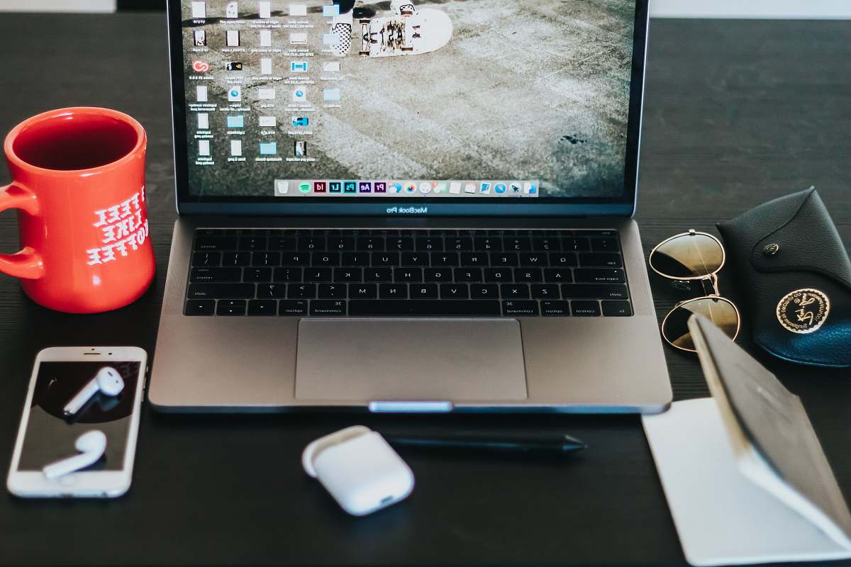 los angeles MacBook Pro turned on on black wooden table desk